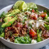 A satisfying Low Carb Burrito Bowl garnished with fresh cilantro and a lime wedge, ready for a healthy weeknight dinner.