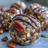 Wholesome oat and honey energy balls studded with sunflower and pumpkin seeds, perfect for a nut-free snack on the go.