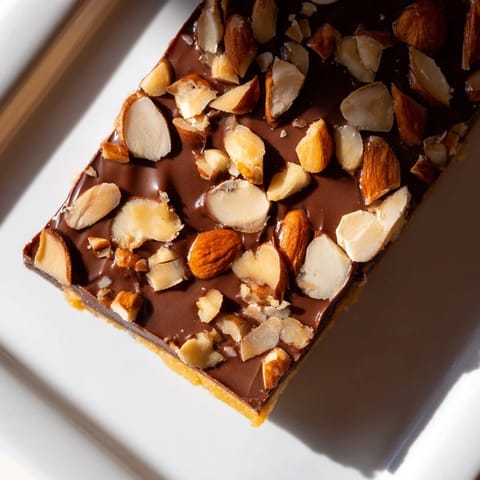 Close-up of freshly made English toffee, glistening with chocolate and ready to break.
