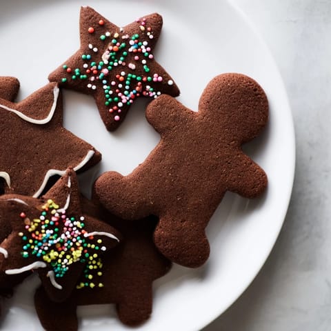 Warm, golden gingerbread cookies, freshly baked and ready for icing and holiday decorating.