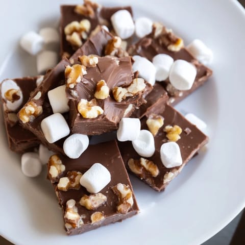 Homemade Rocky Road Fudge, a rich dessert with marshmallows and walnuts, ready to be enjoyed.