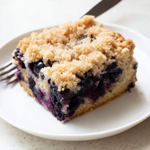 Warm Blueberry Buckle with golden streusel, bursting blueberries, perfect for breakfast or dessert.