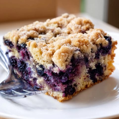 Freshly baked Blueberry Buckle with a crumbly streusel topping, ideal with morning coffee.
