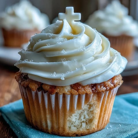 Soft vanilla Communion cupcakes crowned with delicate white edible crosses.