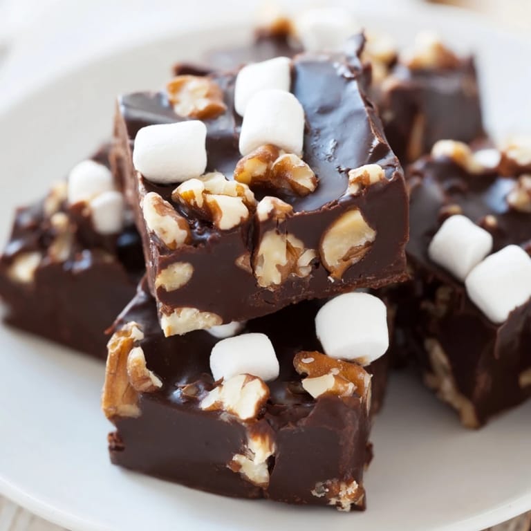 Chilled, square pieces of decadent Rocky Road Fudge with a delightful mix of flavors and textures.