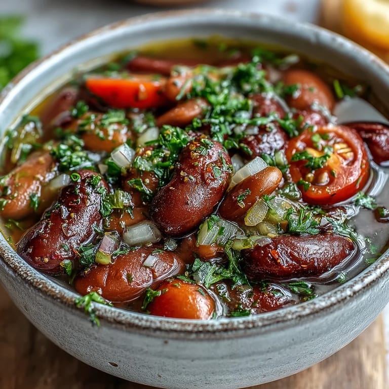 Vibrant Three-Bean Salad Soup featuring tender beans and vegetables in a tangy broth, perfect for a vegetarian meal.
