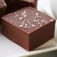 Homemade fudge squares, rich and intensely chocolatey, ready to slice into delicious bite-sized treats.