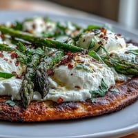 Roasted Asparagus Flatbread with Burrata, a delicious appetizer topped with creamy cheese and lemon.